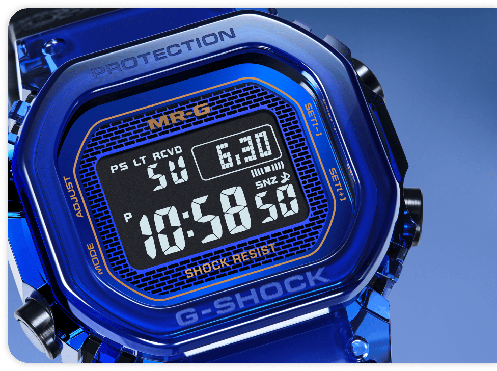 G-Shock MRG-D5000 сағатының көк «кірпіш» өрнекті, 24 караттық алтын жазулары бар циферблаты